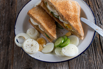 Egg and toast sandwich on wooden table