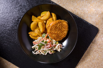 A plate of potatoes, chicken cutlet