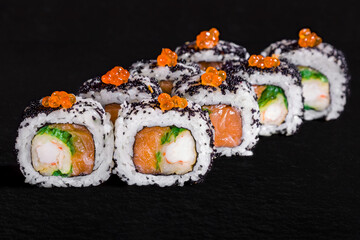 Roll with salmon caviar, black tobiko caviar, cream cheese, eel
