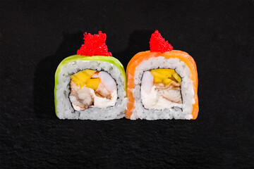 Rolls with tobiko caviar, salmon, rice, nori, fruit, shrimp, eel