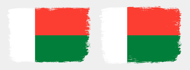 A set of two vector brush flags of Madagascar with abstract shape brush stroke effect