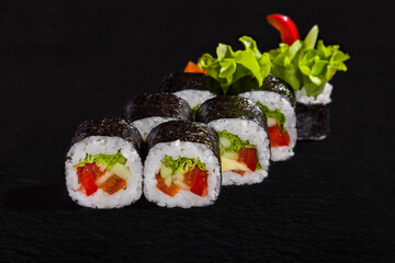 Rolls with nori, rice, frisse salad, cucumber