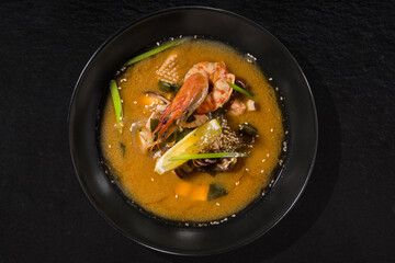 Soup with shrimp, octopus, squid meat, lemon, onion, noodles