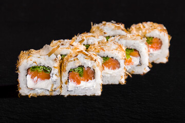 Roll with sprinkles, rice, nori, onion, salmon and cream cheese
