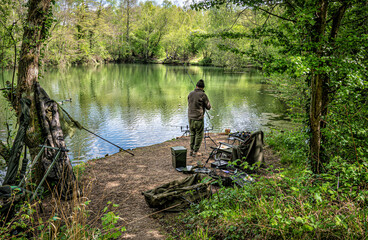 Fisherman by the lake side at Swanick Lakes nature reserve.