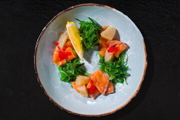Salmon meat with lemon, tobiko caviar, chuka