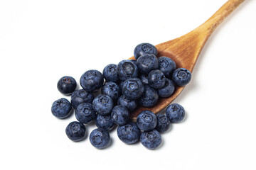 Blueberries on a white background. Wooden spoon full of blueberries. Useful and tasty berry.
