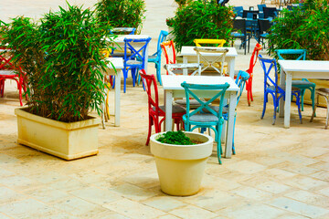 Fototapeta na wymiar Table and chair setup in Italian terrace restaurant in Marzamemi province of Syracuse – Patio in Marzamemi fishing village