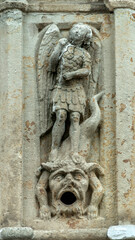 Fototapeta na wymiar Statue de Saint Michel terrassant le dragon sur une fontaine à Aiguilhe, Haute-Loire, France