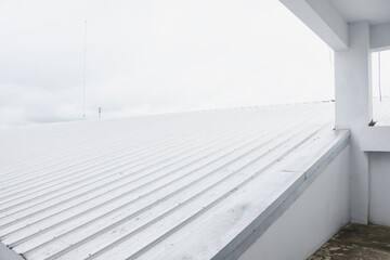 metal sheet roofing on commercial construction with blue sky