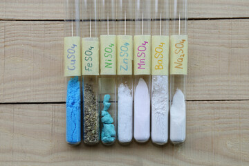 Test tubes with colored crystalline sulfates of various metals: sodium anhydrous - desiccant, zinc,...