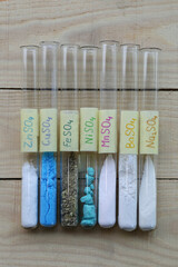 Test tubes with colored crystalline sulfates: sodium anhydrous - desiccant, zinc, copper and iron -...