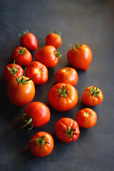 Fresh organic tomatoes, picked from the garden, on dark background. Selective focus.