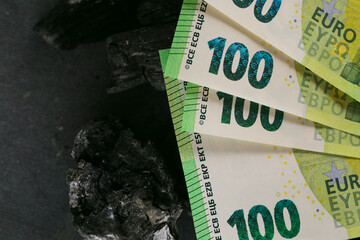 Coal cost in Europe.Charcoal and one hundred euro bills .Coal industry in the European Union.Buying...