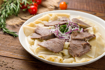 Beshbarmak, Uzbek kitchen on old wooden table
