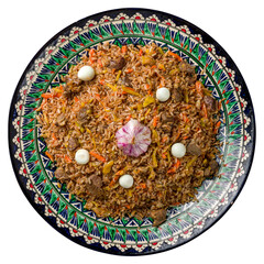 pilaf with beef, eggs, carrot on beautiful uzbek plate isolated on white background top view