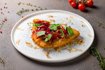 Vienna schnitzel from veal on plate on brown table