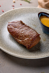roast beef Steak with honey mustard sauce on plate on brown table