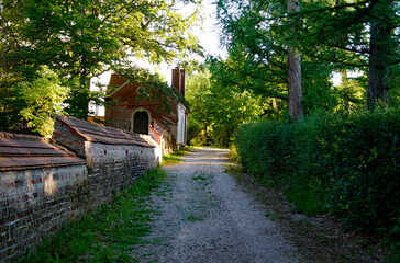 a green shadowy alley in the Bavarian village Irsee (Irsee, Bavaria, Germany)