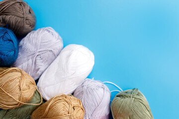 Skeins of wool yarn and knitting needles.