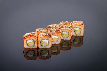 California roll with shrimp on black with reflection
