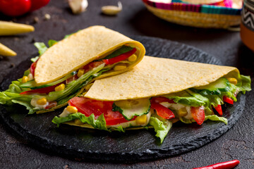 Vegetable Quesadilla on black stone plate side view macro close up