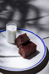 Pieces of chocolate pie with a glass of pullets