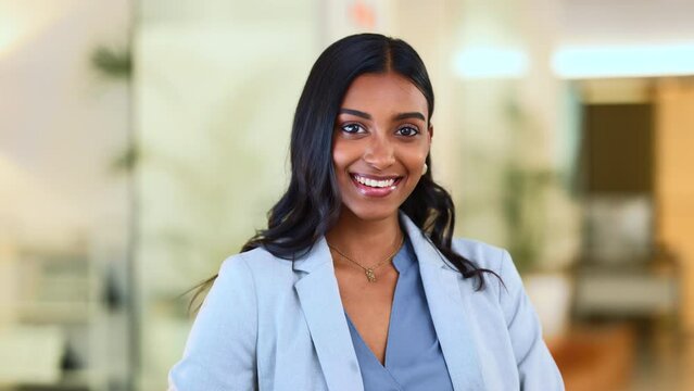 Successful female executive typing or reading an email. Confident business woman using a computer at work. A beautiful corporate receptionist sitting in an office chair, smiling.