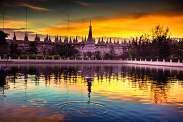 Reflection of pagodas on the lake in colorful sunrise in the morning at Myanmar.