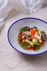 Salad with ham, zucchini, onions, pesto sauce, and nasturtia leaves