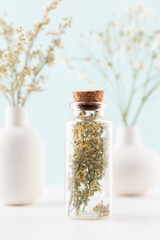 Dried herbal flowers with bottle. Homeopathy background.