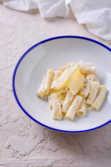 Spaghetti in sauce with parmesan slices