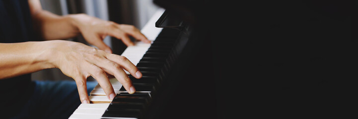 close up of hand people man musician playing piano keyboard with selective focus keys. can be used...