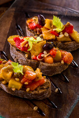 Three bruschetta with baked vegetables.