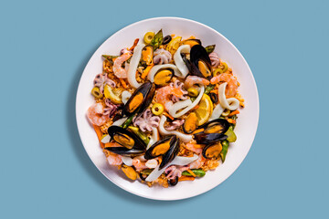 Salad with mussels, octopus, squid rings, lemon, shrimps, olives, rice, carrots and beans