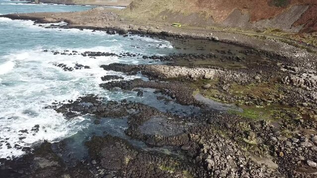 Giants Causeway (Fly Over Bay Follow Tour Bus Drone Shot 4K)