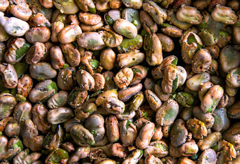 Fototapeta na wymiar Broad beans stewed with onion and spices in a pan