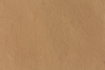 A painted plaster wall texture. A beige concrete wall background.