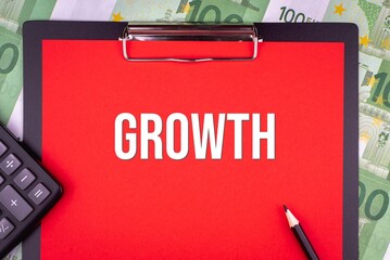 GROWTH - word on the background of money, a notepad and a pencil with a calculator. Business concept (copy space).