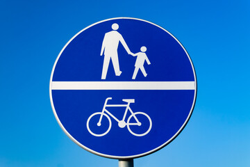 Road sign against the sky. Bicycle path, pedestrian path.