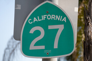 Green California Route 27 Sign Against Blurred Natural Background