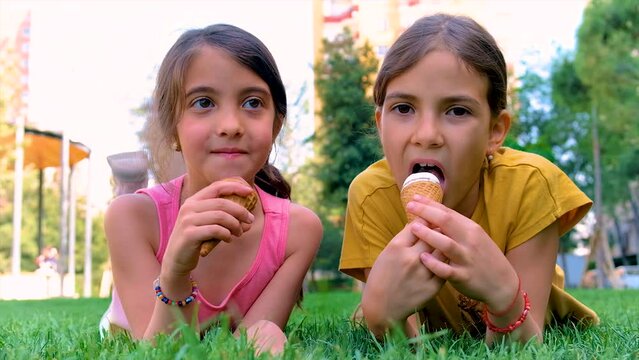 A child eats ice cream in the park. Selective focus.