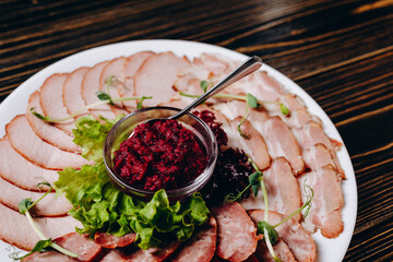 There is a plate of sausages in the plate in the cafe.
