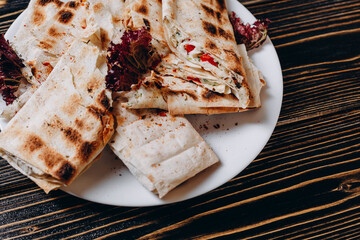 There are a lot of pitas on the white table in the restaurant.