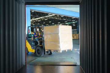 Forklift are loading into cargo containers at warehouses, ports, freight forwarding, cargo supply...
