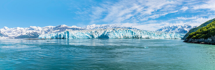 A panorama view of the end of the Hubbard Glacier in  Disenchartment Bay, Alaska in summertime