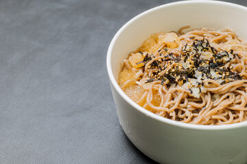 Korean food Naengmemilguksu, a winter delicacy, this buckwheat noodle dish is served in a cold chicken- or beef-based broth and topped with cold slices of beef and egg as a garnish.