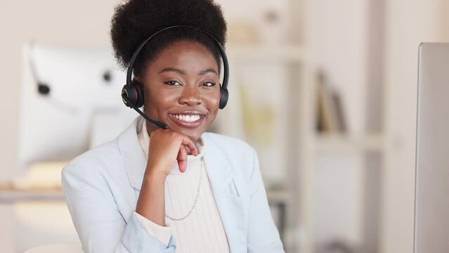 Confident female call center agent happy and having a successful day in the office. Portrait of a African sales woman happy to help. Proud customer service employee smiling helping consumers