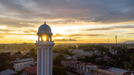Mosque minaret with sunset in the background, Aceh, Indonesia.