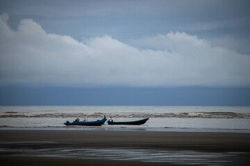 boats on the beach on a grey day